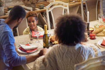 Wall Mural - holidays and celebration concept - happy family having Christmas dinner at home.