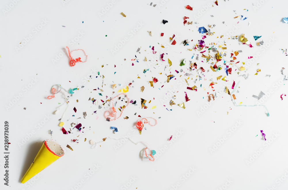 Exploding party popper on white background - obrazy, fototapety, plakaty 