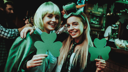 two girls holding a shamrocks. st patrick's day.