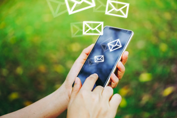 Woman hand using smartphone to send and recieve email for business.