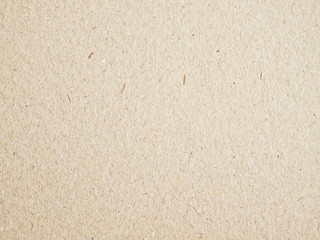 Texture of beige cardboard closeup, abstract paper background