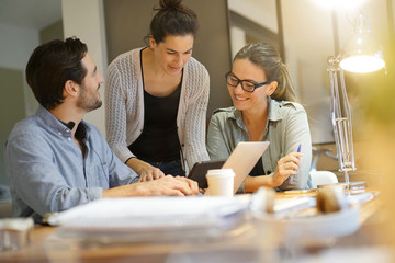 Colleagues workshopping business ideas in modern co working space