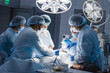 © alfa27 - Group of concentrated surgeons engaging in rescue of male patient in operation room at hospital, emergency case, surgery, medical technology, health care and disease treatment concept