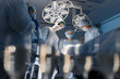 © alfa27 - Blurred figures of surgeons in medical uniforms performing surgery in operation theatre, copyspace