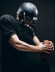 Wall Mural - American football player with helmet and armour in the decisive game takes responsibility of the results of the game .