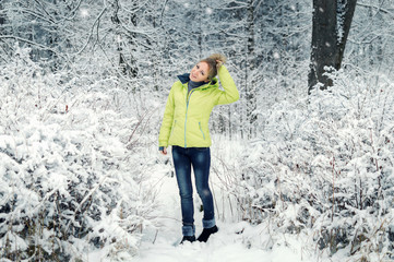 Beautiful young girl in a white winter forest