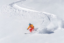 Freeride Skier Skiing Downhill Through Deep Powder Snow