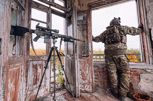 Sniper in a bulletproof vest and helmet looks out the window near a large  sniper rifle - Buy this stock photo and explore similar images at Adobe  Stock | Adobe Stock