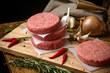 Raw beef burger, traditional barbecue, still life with vegetables and meat