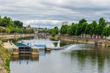 Wall Mural - Banks of the Mayenne river, City of Laval, Mayenne, Pays de Loire, France. August 5, 2018