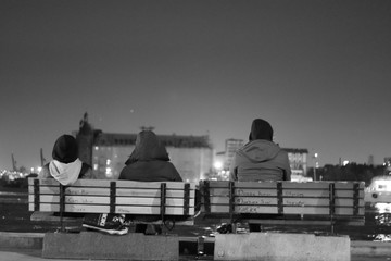 3 friends sitting on 2 banks