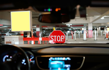 Wall Mural - stop sign in front of the car at parking lots