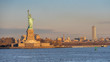Statue of Liberty During Sunrise with New Jersey City in the background