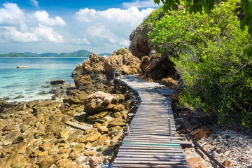 Sticker - Tropical island rock and wood bridge on the beach with blue sky. Koh kham pattaya thailand.