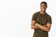 © Cookie Studio - Friendly-looking delighted self-assured handsome african-american male cross arms aganst chest and smiling as having ambitiouns and determined to follow own dreams over white background