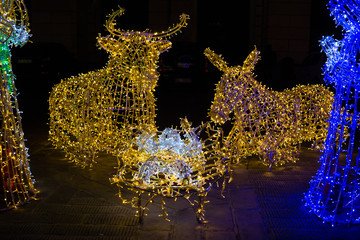 Close-up of Christmas nativity scene illuminated with colored lights