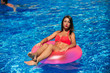 © Aleksandr - Sexy girl sunbathing in the pool on a round mattress