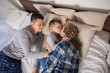 © dmitriisimakov - the family morning in the bedroom on the bed mom dad son