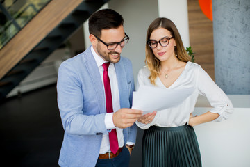 Young business people analyzing documents