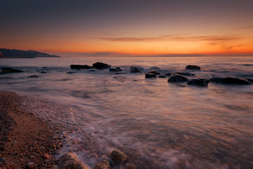  Seascape during sunrise. Beautiful natural seascape, blue hour. Sea sunrise at a Black coast near Varna, Bulgaria. Magnificent sunrise with clouds in the middle of April.