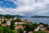 Fototapeta Do pokoju - tiled roofs and cruise ship on background of the mountains in Montenegro