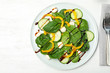 Fresh vegetable salad with balsamic vinegar served on wooden table, top view. Space for text