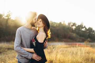 Pretty young romantic couple spend time together outdoor.