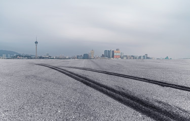 Sticker - Panoramic skyline and buildings with empty tire printed road in Macao