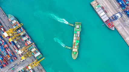 Container ship in export and import business logistics and transportation. Cargo and container box shipping to harbor by crane. Water transport International. Aerial view and top view.