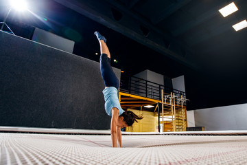 Young woman sportsman fitness jumping on club trampoline