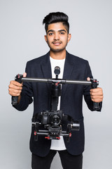 Professional indian man videographer with gimball video slr isolated on white background