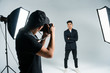 © dianagrytsku - Photographer working with model in studio with equipments. Photographer work process.