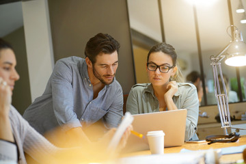 Colleagues looking over ideas in co working space