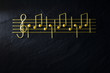 Musical Christmas sheet music paste isolated on a black textural background.