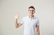 © Leika production - Affable  guy dressed in a white t-shirt and jeans is on a white background in the studio