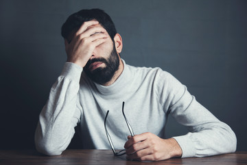 Wall Mural - sad man hand in face