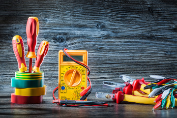 Wall Mural - composition electric tools screwdrivers multimeter pliers wires on gray wood.