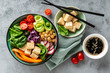 © Sunny Forest - Buddha bowl salad with chickpeas, sweet pepper, tomato, cucumber, red cabbage kale, fresh radish, spinach leaves and tofu cheese, healthy balanced clean eating concept, top view, flat lay.
