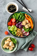 Sticker - Buddha bowl salad with chickpeas, sweet pepper, tomato, cucumber, red cabbage kale, fresh radish, spinach leaves and tofu cheese, healthy balanced clean eating concept, top view, flat lay.