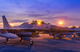 Silhouette fighter jet military aircrafts parked on runway in twilight time with light airport during air flight show in the night