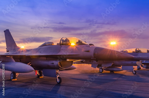 Fotografia Silhouette fighter jet military aircrafts parked on runway in twilight time with