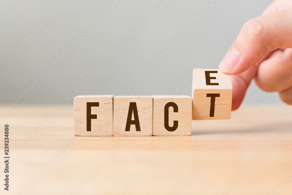 Face to Facts concept. Hand flip over wooden cube block - obrazy, fototapety, plakaty 