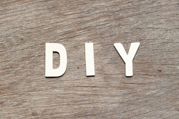 Sticker - Alphabet letter in word DIY (abbreviation of do it yourself) on wood background