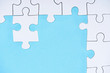 © LIGHTFIELD STUDIOS - top view of white puzzles arrangement on blue background