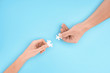 © LIGHTFIELD STUDIOS - cropped shot of man and woman with white puzzle pieces on blue backdrop, cooperation concept