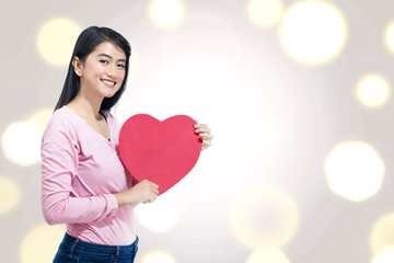 Wall Mural - Young asian woman with red heart on her hands