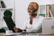 © LIGHTFIELD STUDIOS - cheerful african american businesswoman holding clipboard in modern office