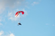 A hang glider in flight with a blue sky 3