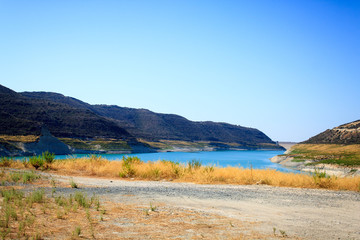 Beautiful view of the blue lake surrounded by mountains on the island of Cyprus