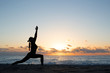 © junky_jess - Human silhouette doing yoga on the beach in front of rising sun
